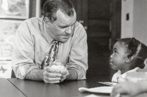 Richard M. Daley talking with a young girl.